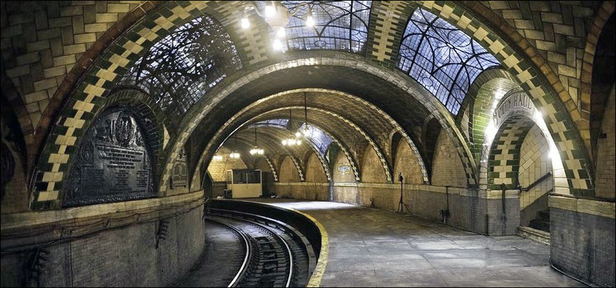 Inside of an empty train station platform and no train on the tracks.