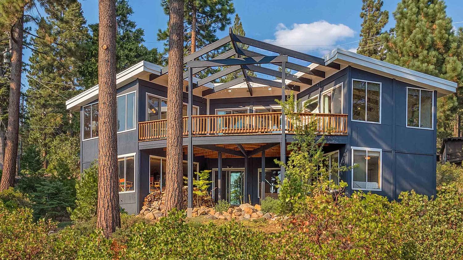 Back view of a blue-painted two story home in Tahoe City.