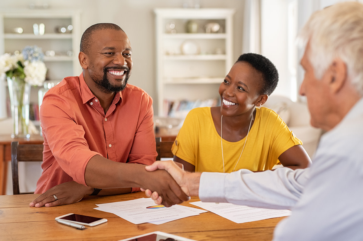 People working with their real estate agent helping them get fair housing