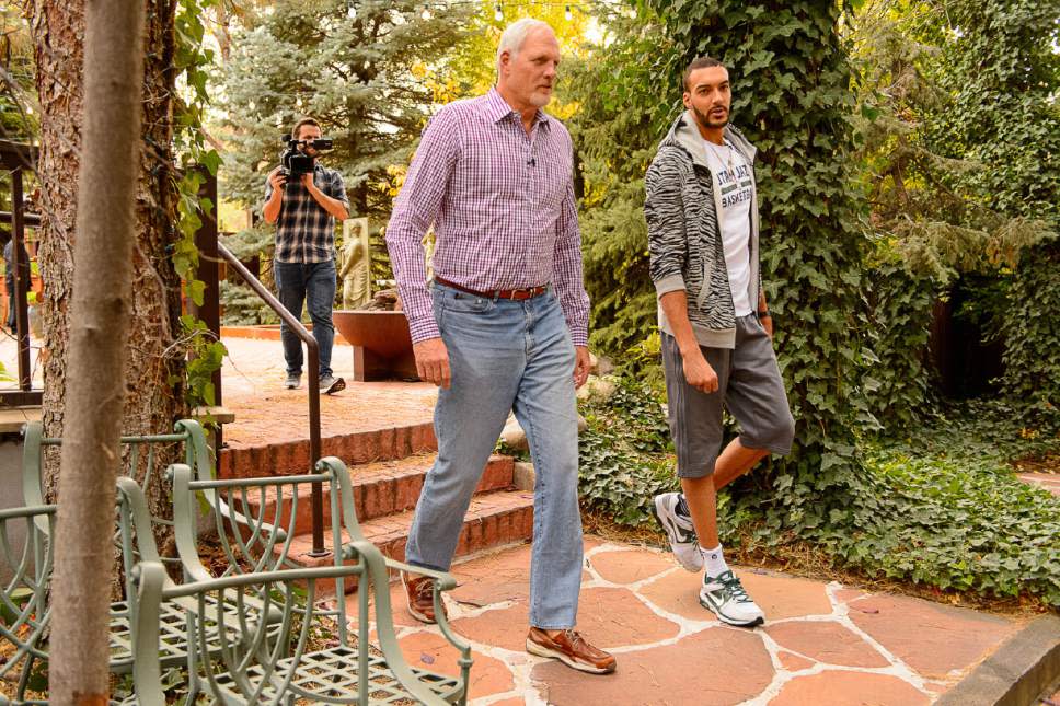 Two men walking, camera man following close behind. 