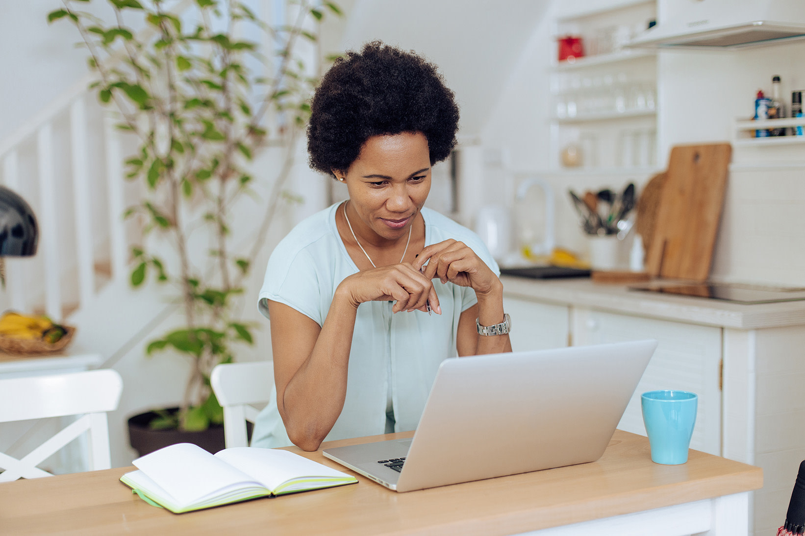 A woman looking at a laptop