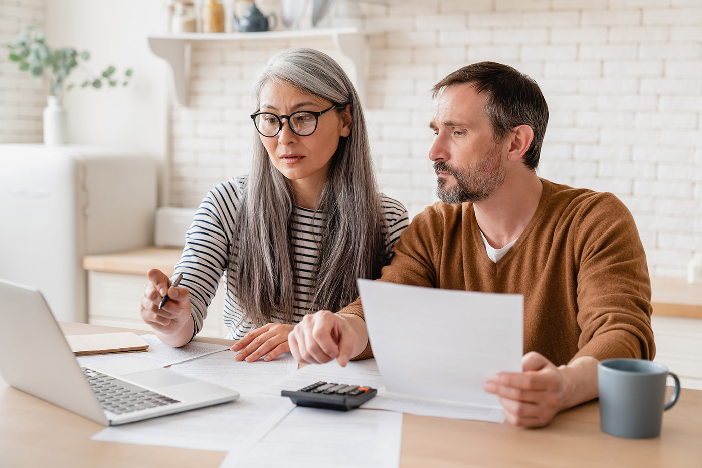 Two people looking at a laptop