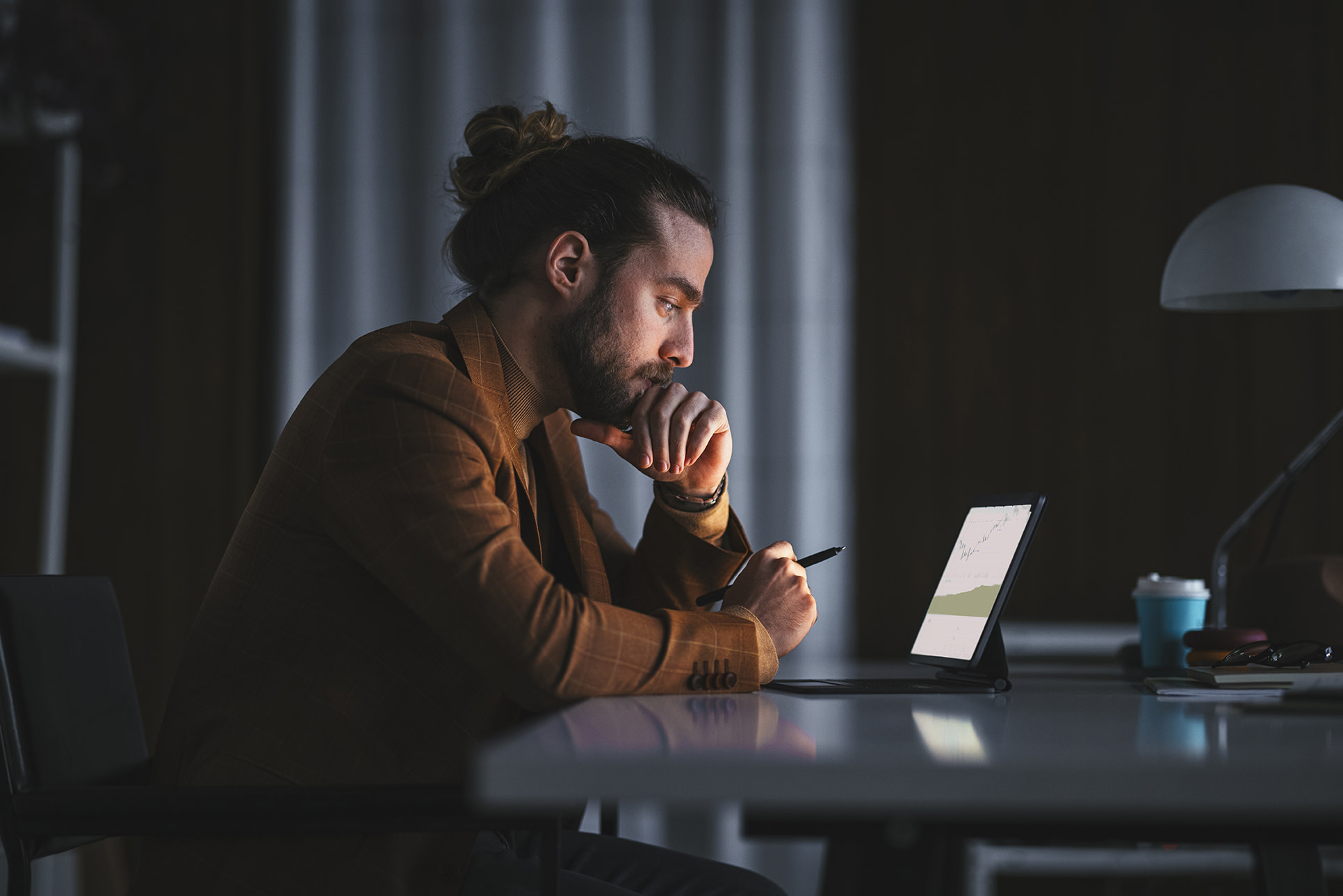 A man using a tablet in the dark