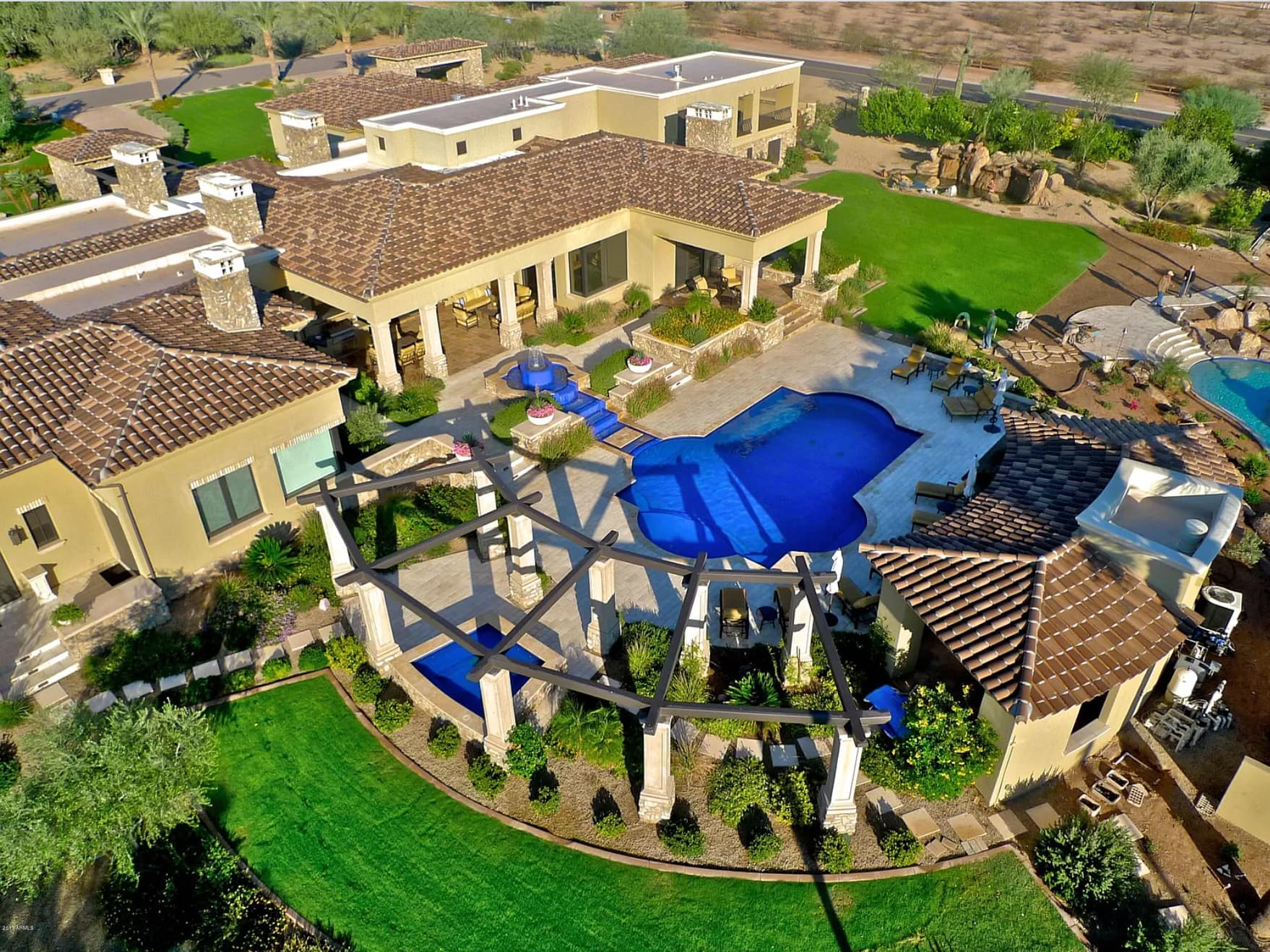 Sky view of a home with a pool. 