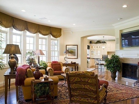 The foyer of the home with a couch and two chairs. 