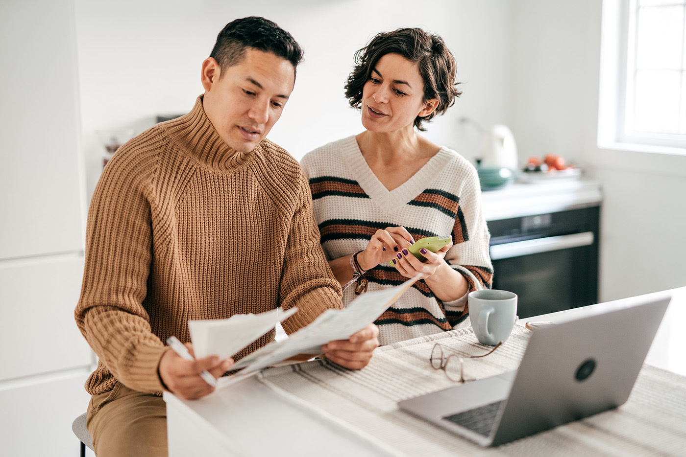 Two people looking at sheets of paper