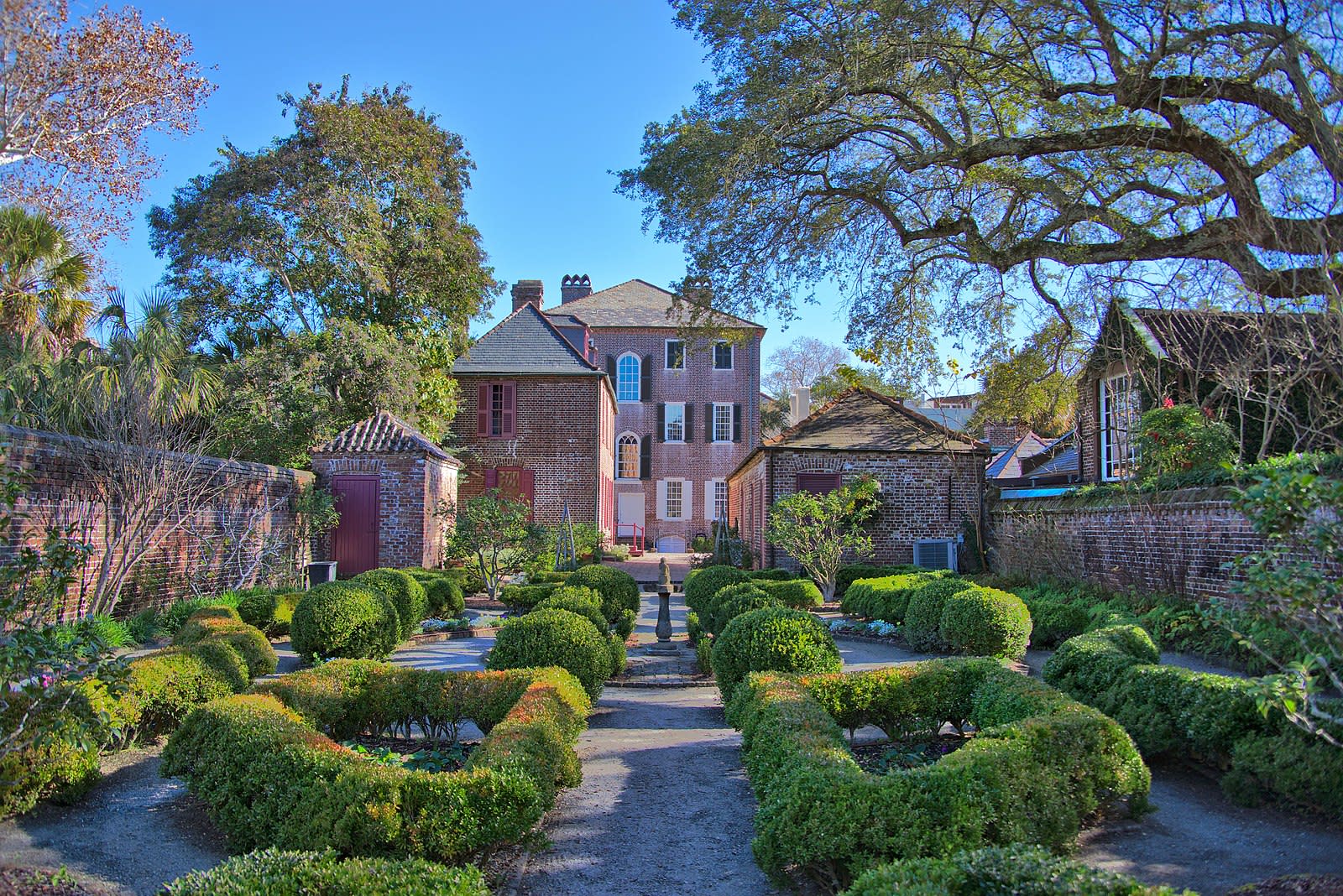 Back garden with a large Georgian style home in the background.