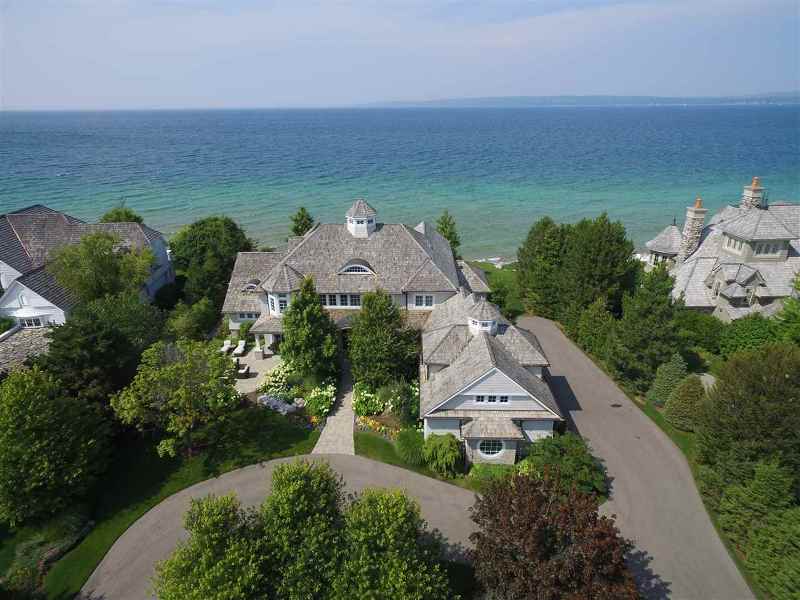 Aerial view of the front of the Bay Harbor estate with water in the background.