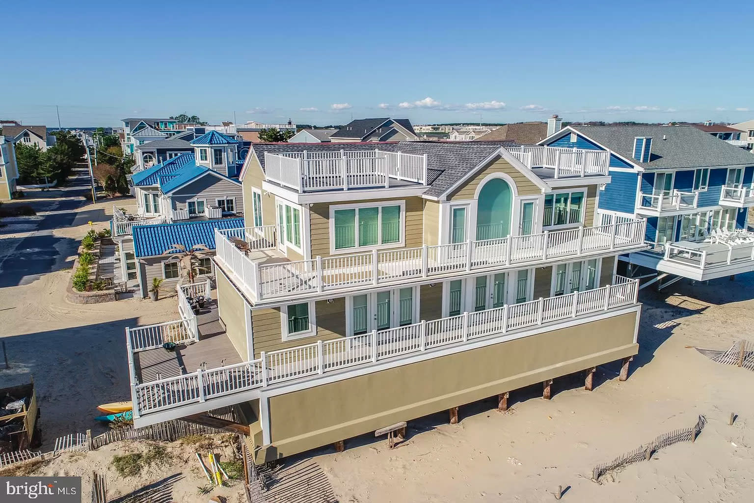 Beige beach house, with 4 decks. 