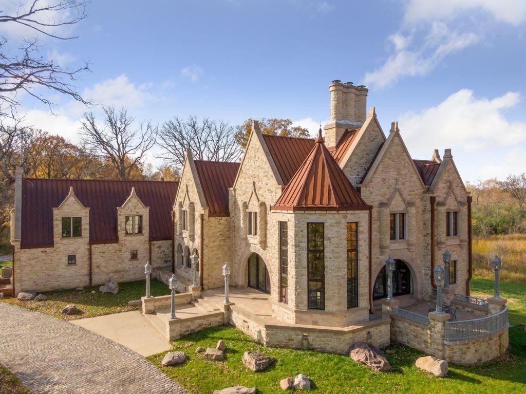 Light brown brick with a reddish orange colored roof. 