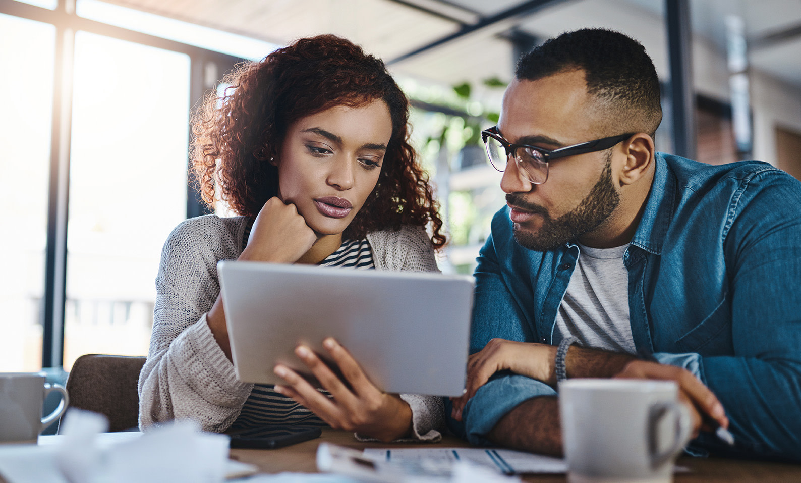 Two people looking at a tablet