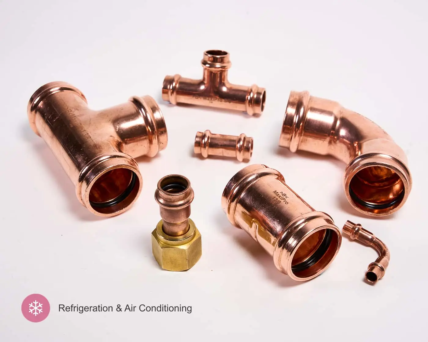 Assorted copper pipe fittings including elbows, tees, and couplings arranged on a white background.