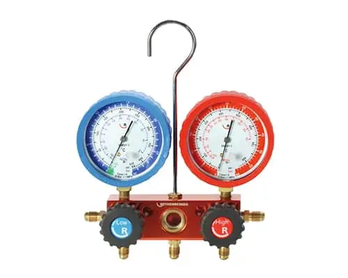 Two pressure gauges with blue and red casings mounted on a red manifold with brass fittings and a metal hook.