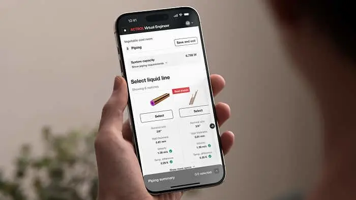 Hand holding smartphone displaying ACTROL Virtual Engineer app with liquid line selection interface and piping options