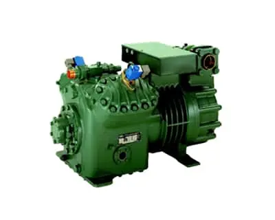 Green semi hermetic compressor unit with cooling fins and multiple valve connections on white background