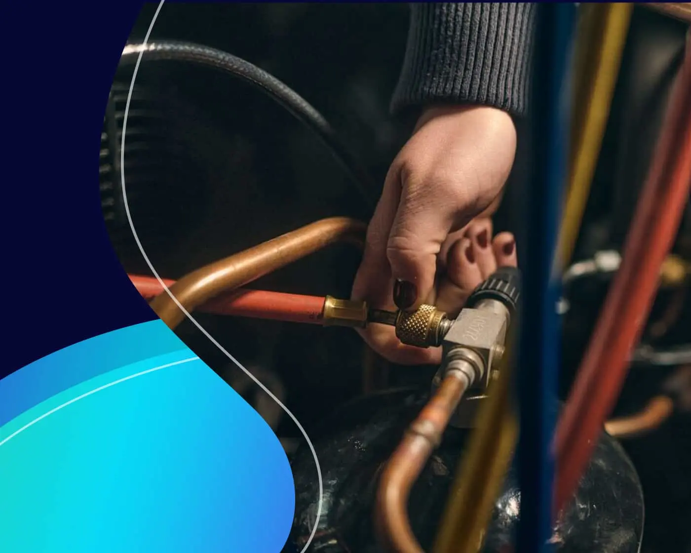 Hand holding a brass valve connected to copper pipes during HVAC maintenance or repair work.