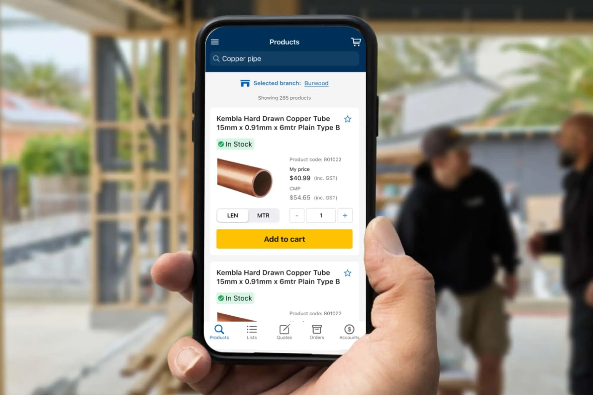 Hand holding smartphone displaying product page for copper pipe with pricing and add to cart button.