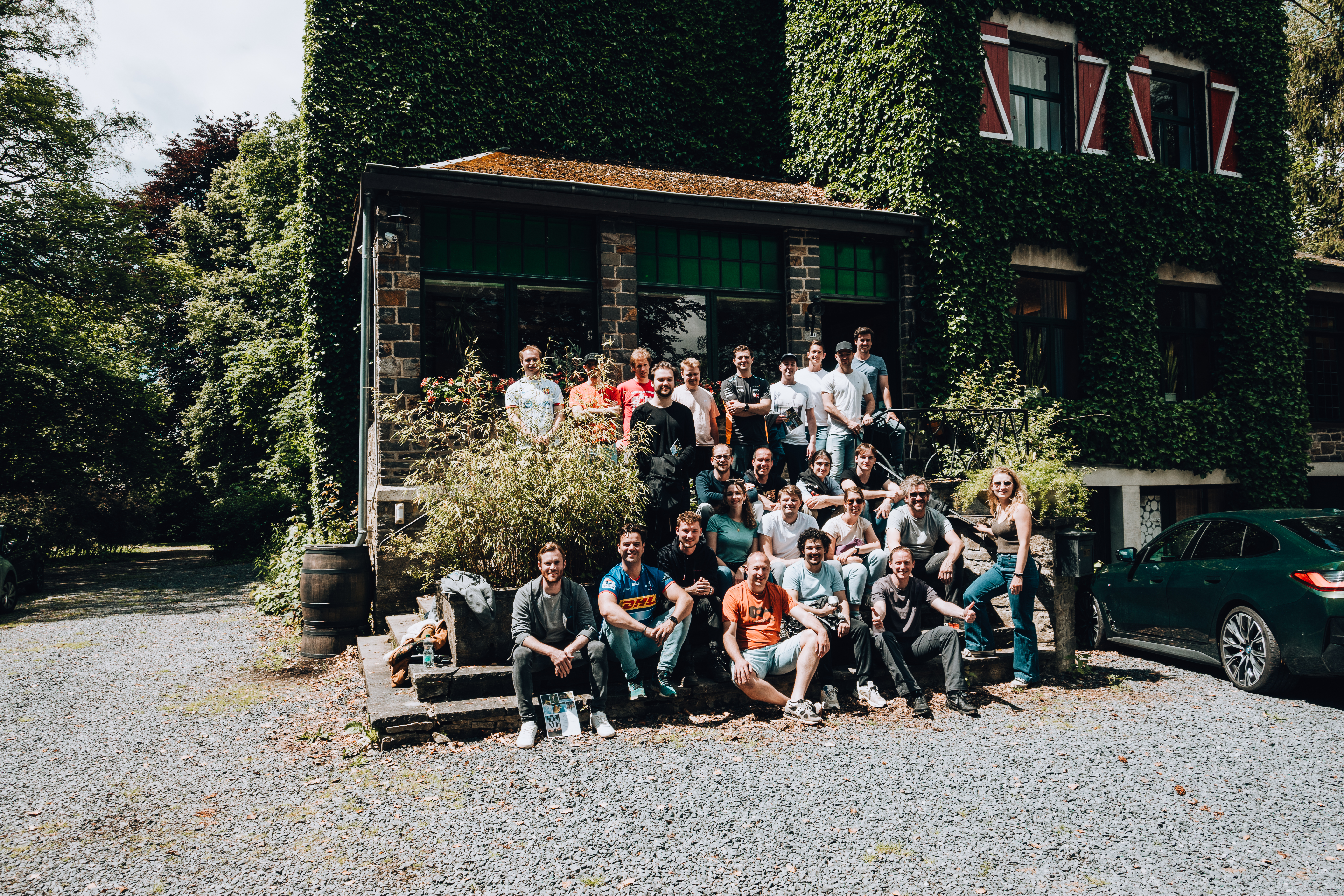 our team is posing in front of Les Ondes in the Belgian Ardennes during our team weekend 