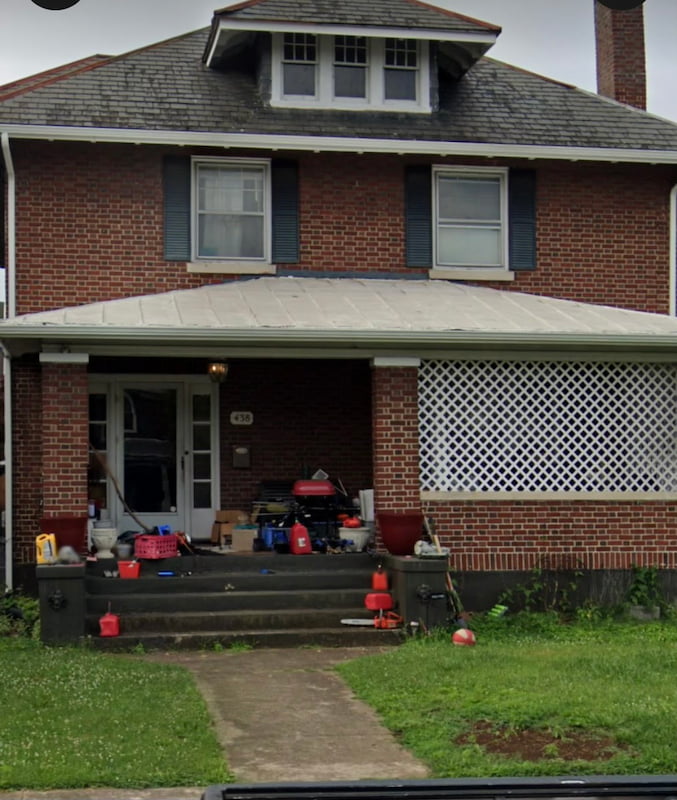 House before cleanup with lots of junk on the porch