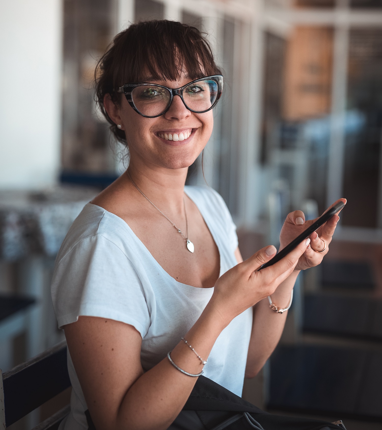loyalty and rewards program woman smiling while holding smartphone for 2019 ecommerce trends