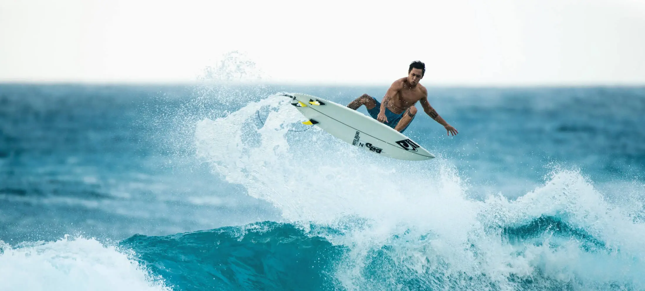man riding the waves on an oneill surfboard