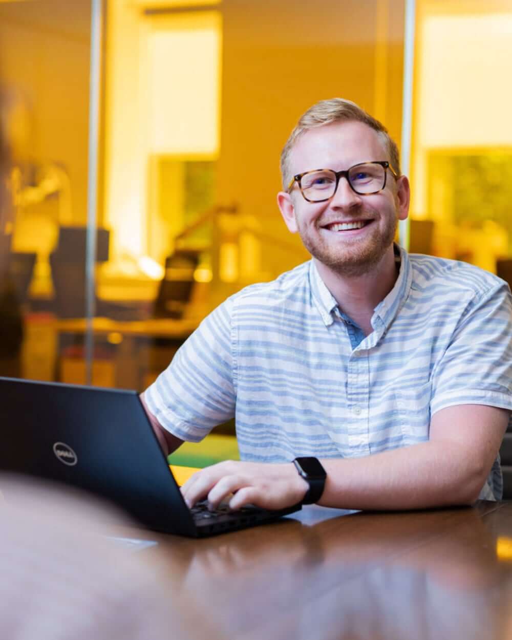 Man on laptop smiling