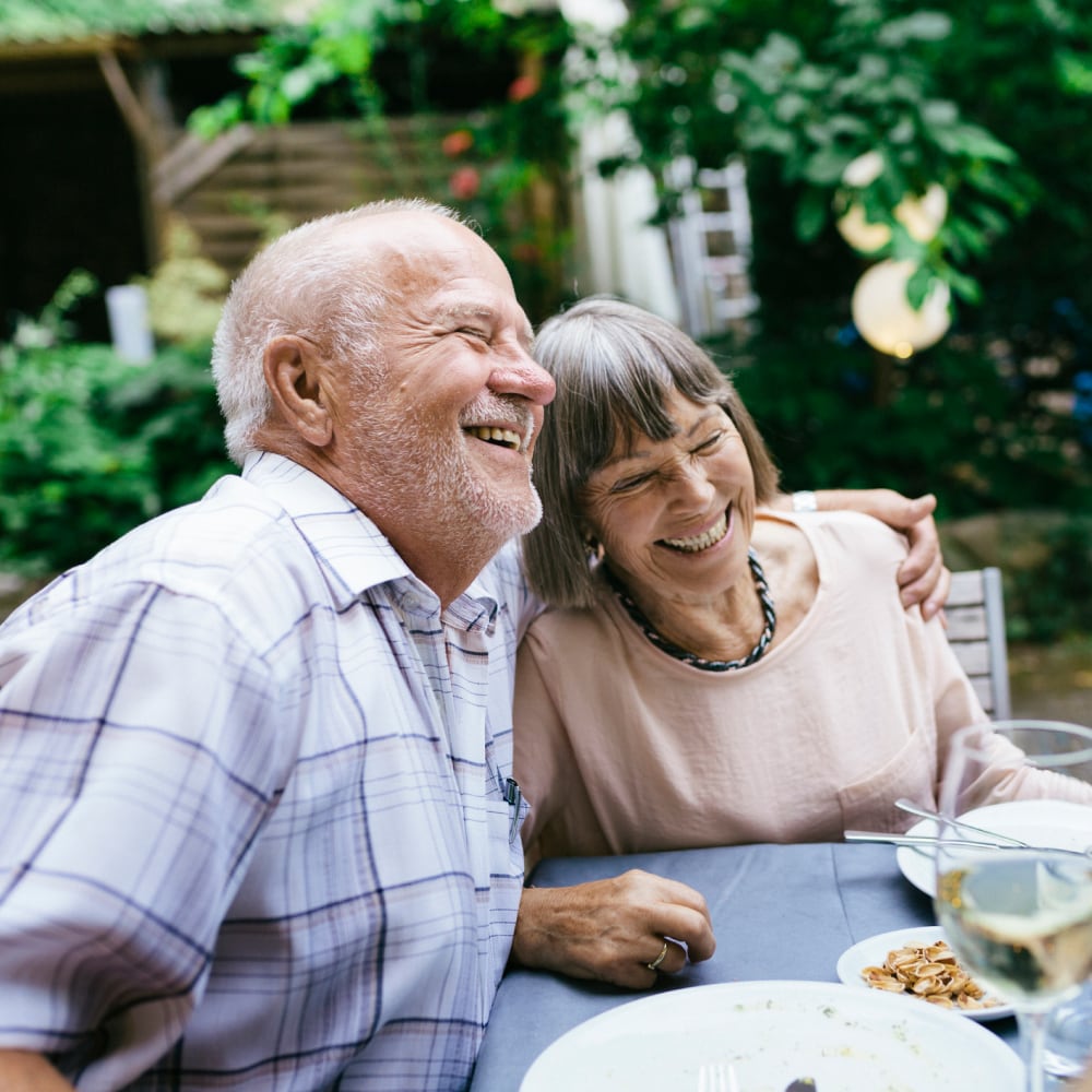 Older couple sitting at table and smiling
