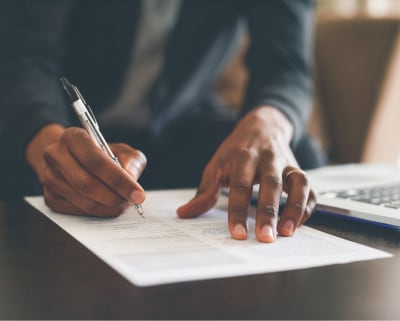 Close up of hands filling out form