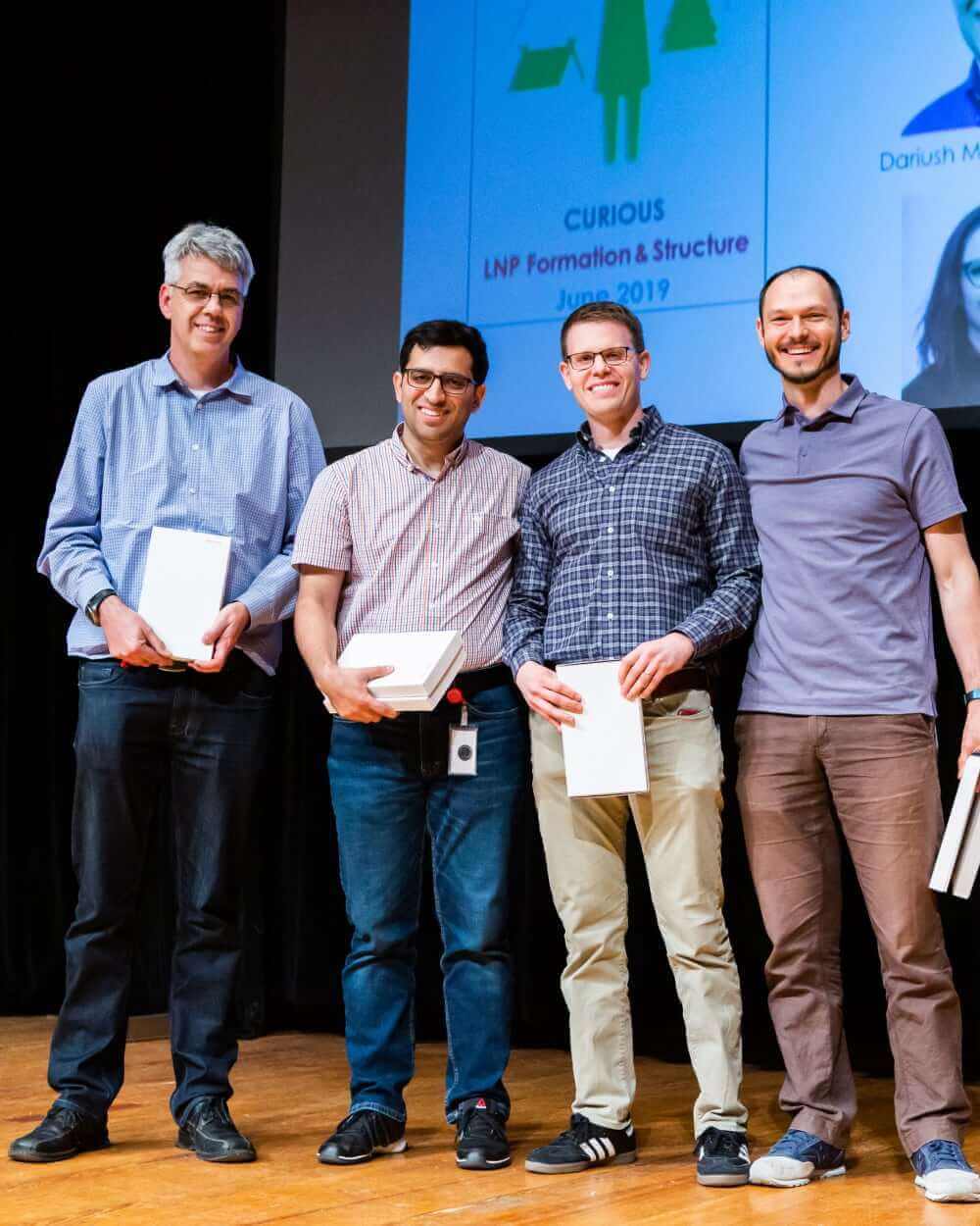 Group of men on stage smiling