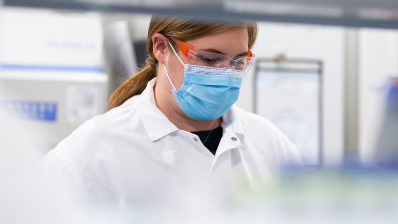 A Moderna lab professional working on new mRNA discoveries