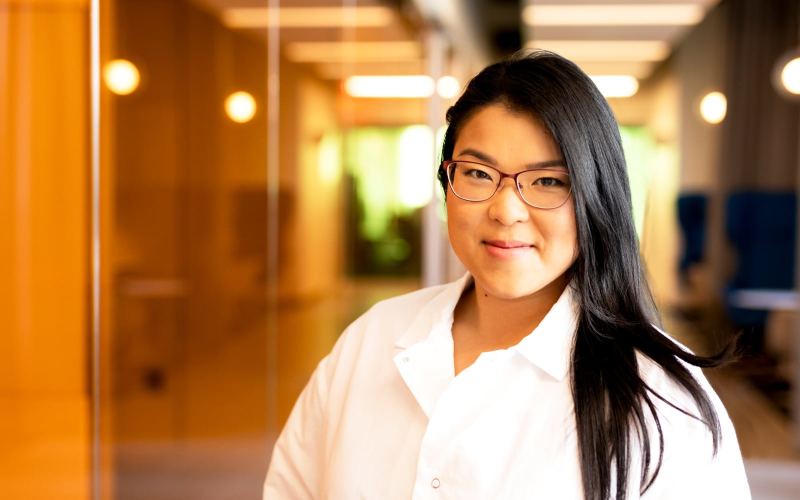 Woman in lab coat smiling