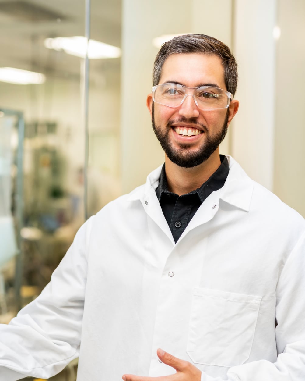 Man in lab gear smiling