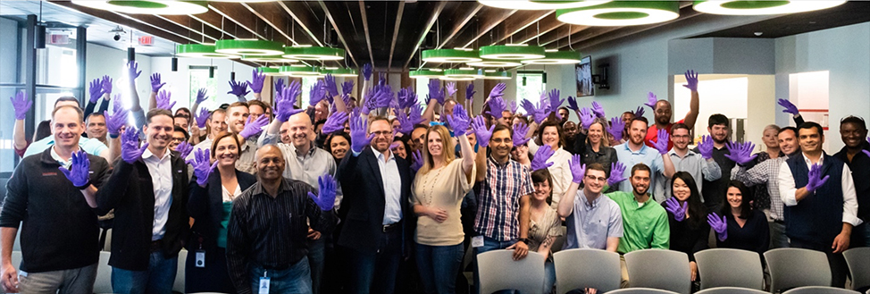 Moderna staff waving with purple gloves