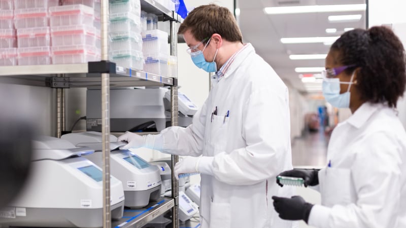 Moderna colleagues performing analysis using a PCR thermocycler