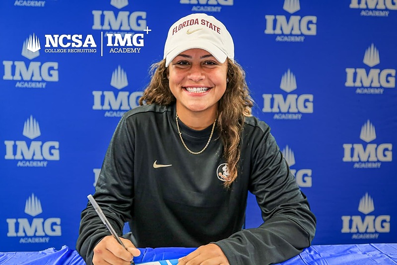 Student-athlete signing a college commitment at IMG Academy, wearing a Florida State cap, with NCSA College Recruiting and IMG Academy logos in the background.