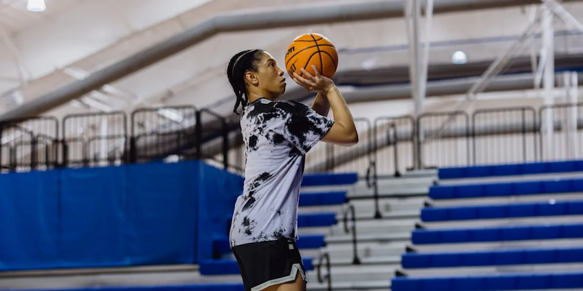 Student-athlete practices basketball shooting form on an indoor court at IMG Academy.