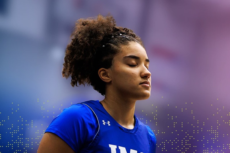 IMG Academy athlete standing with eyes closed and calm expression, practicing mindfulness and mental focus during training.