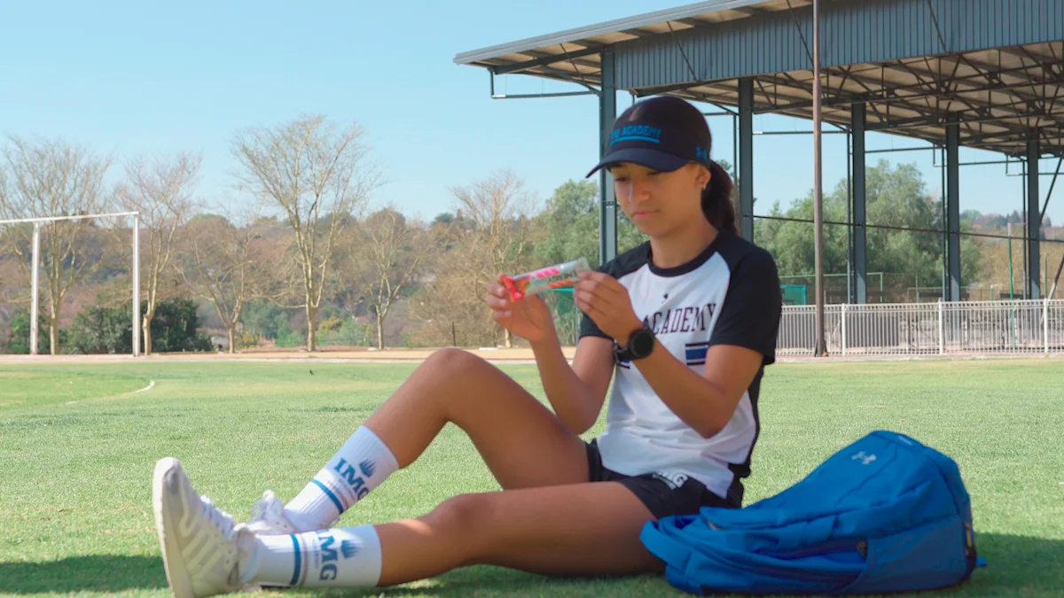 Female student reading the nutrition label on a protein bar.