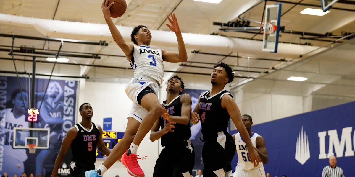 A basketball player drives toward the basket during a game.
