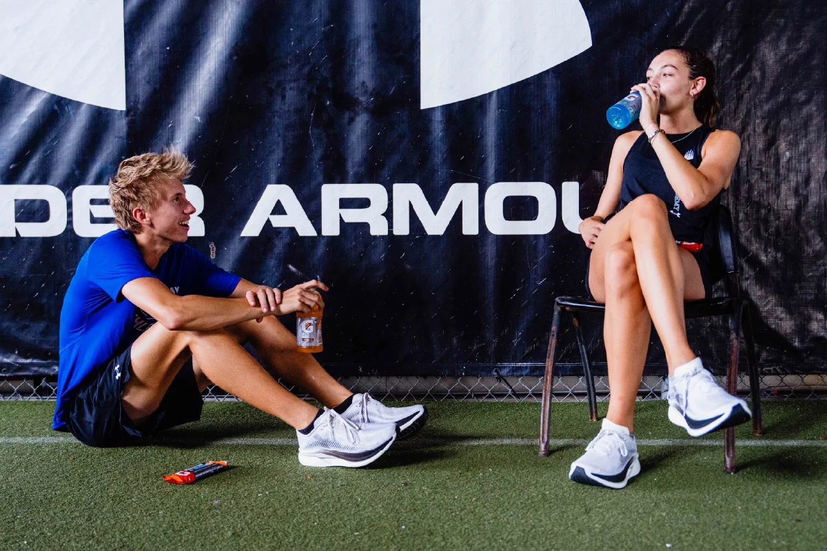 Male and female athlete hydrating with Gatorade.