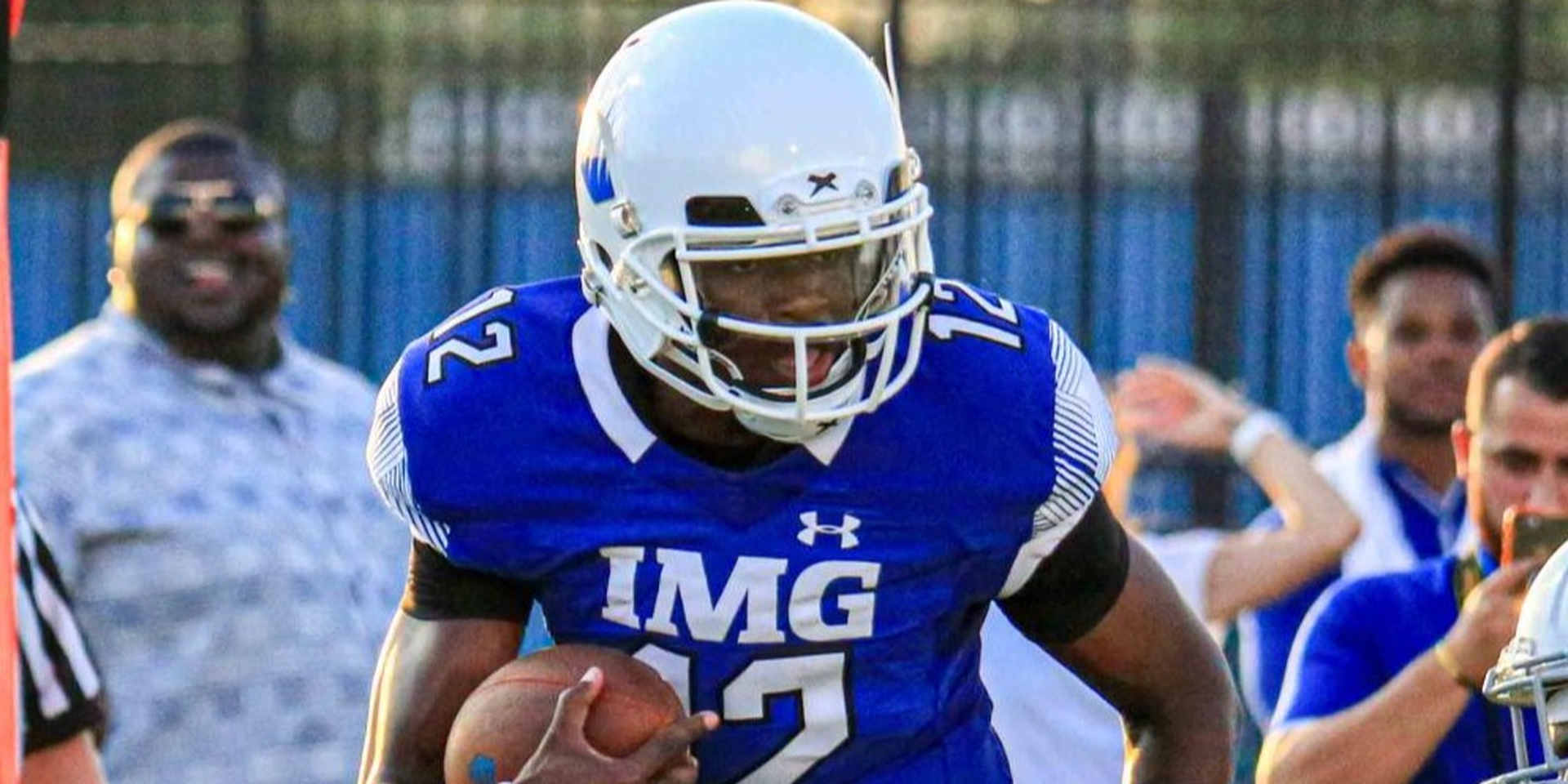 A helmeted football player stands ready on the field.