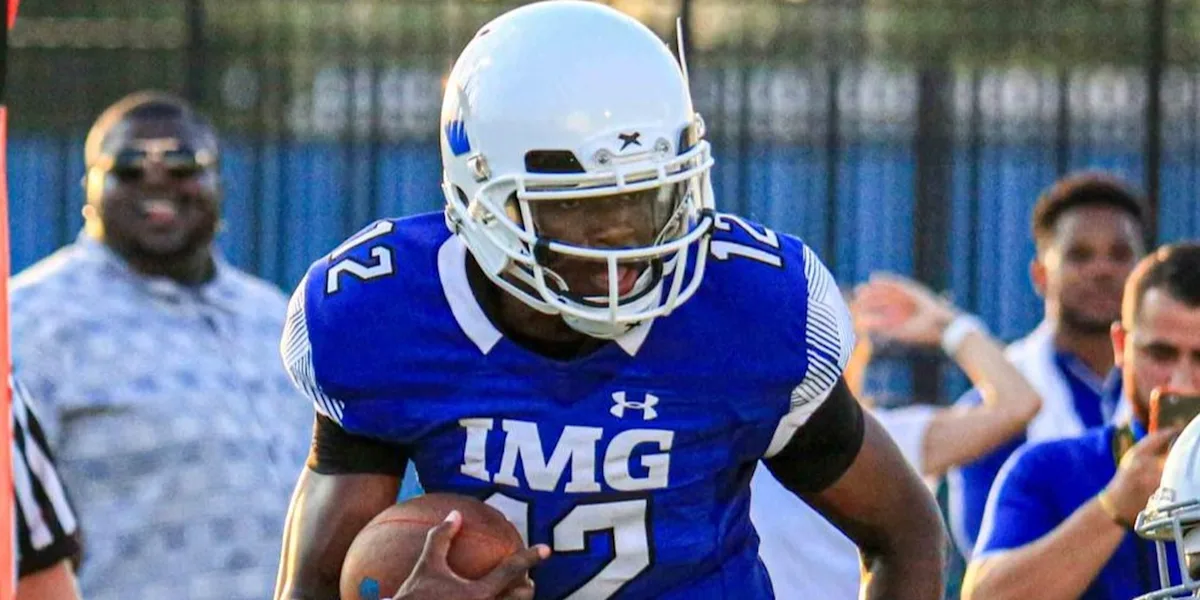 A helmeted football player stands ready on the field.