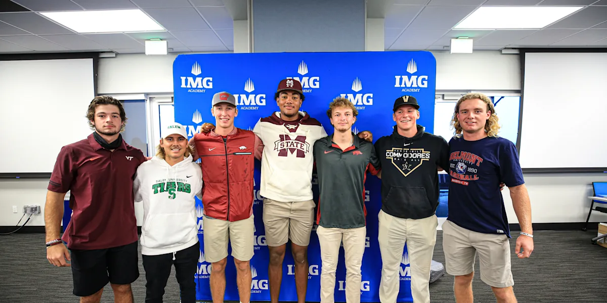 Student-athletes pose together in front of an IMG Academy backdrop.