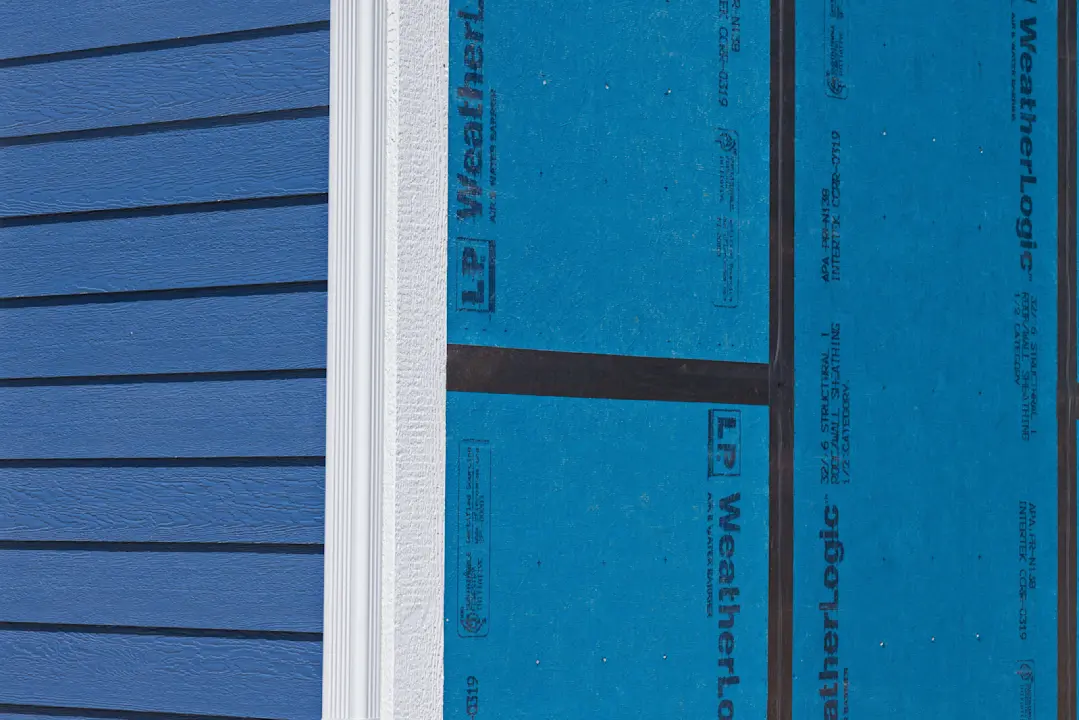 close up of house with blue siding no window