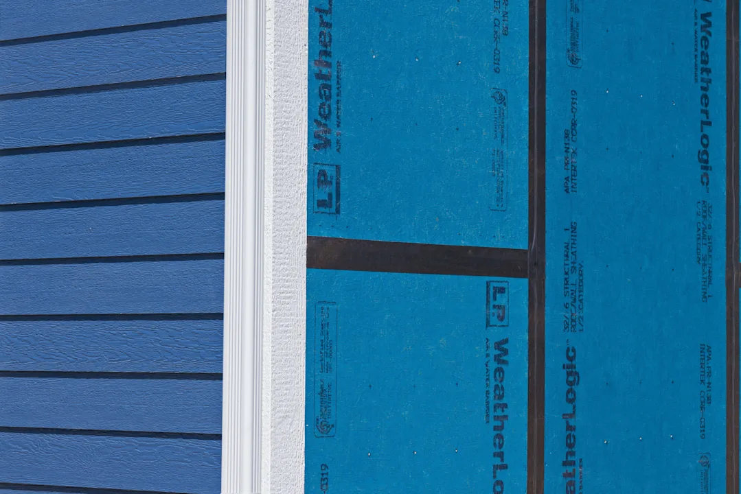 close up of house with blue siding no window