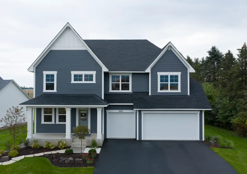 two story house with blue lap siding