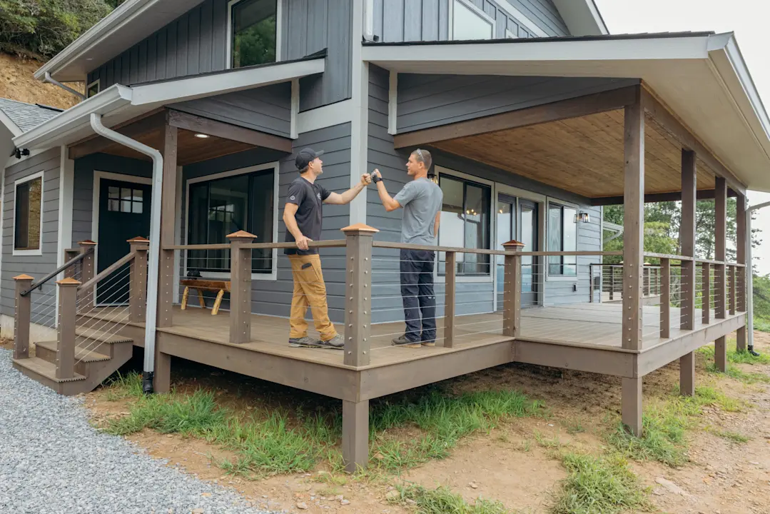 Image of two builders looking at home