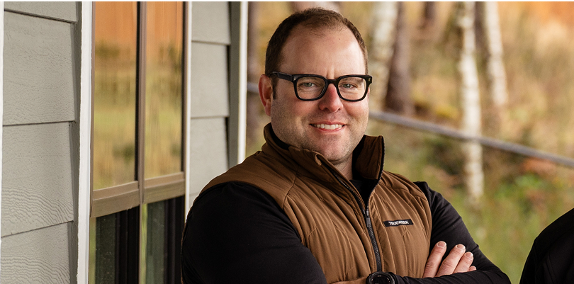 Tim Uhler of Awesome Framers crossing his arms and smiling at the camera