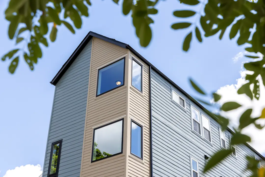 two level home with black and brown lap siding