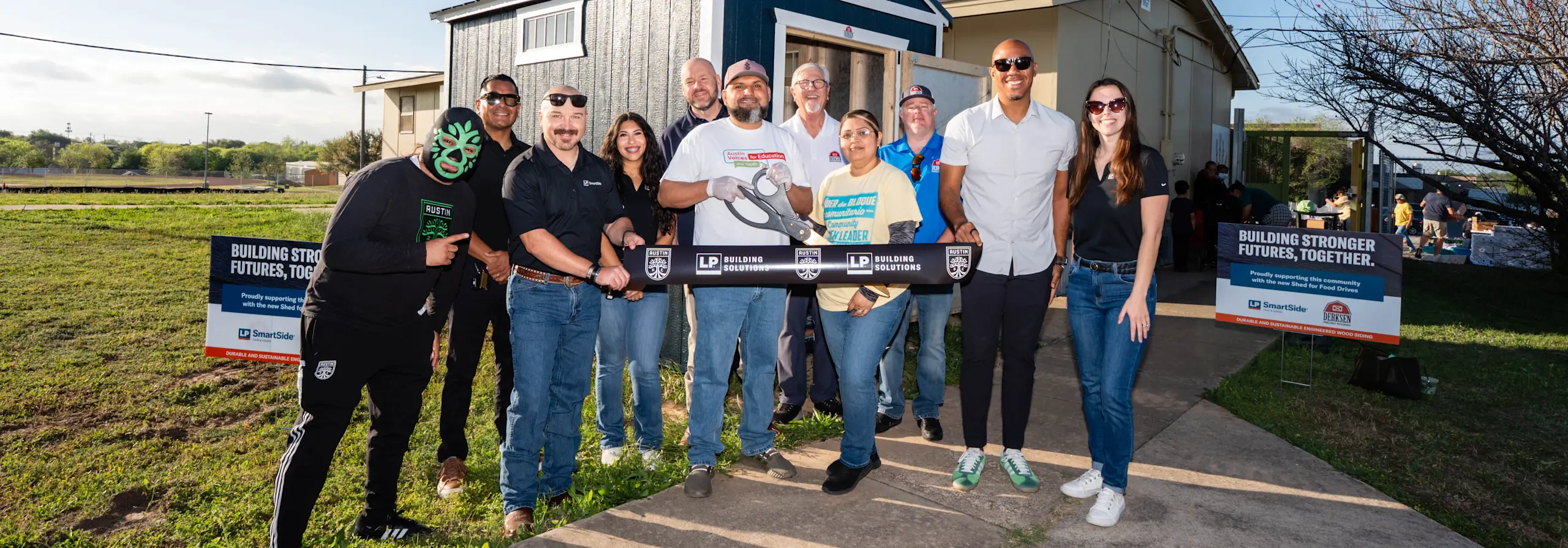 Image of members in front of shed for ribbon cutting